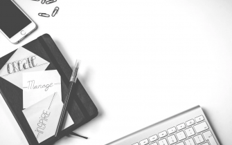 Black and White Image of a Keyboard and Notebook